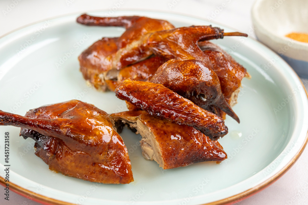 Crispy roasted pigeon on a plate