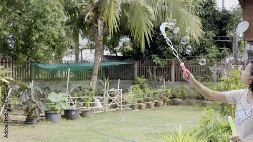 Woman Is Playing With A Bubble Wand, Video footage for documentary film and cinematic in lifestyle scene.