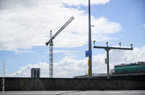 Obraz na płótnie Construction crane above the building under construction. HEIGHT CHECK sign on the post. Auckland. w salonie