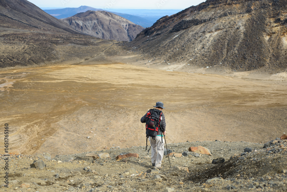 Backpacker hiking Tongariro Alpine crossing, Tongariro National Park. New Zealand.