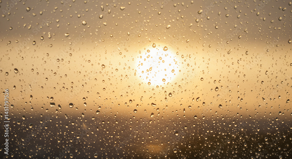 Obraz premium Sunset behind raindrops on a window with copy space for text