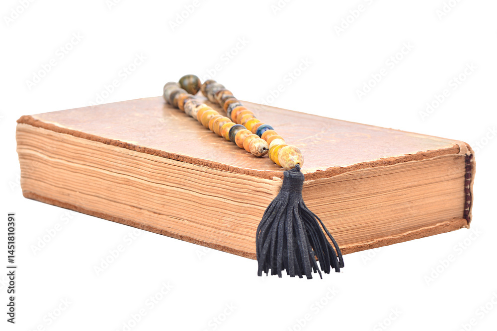 Old book with beads on a white background isolated
