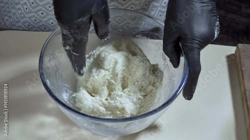 Cooking sweet food. The cook takes out a ball of cottage cheese cookie dough from a glass bowl. Cooking cookie dough. Slow motion video 100fps.