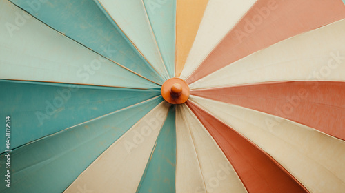 Colorful striped patio umbrella creates shade at outdoor cafe during sunny afternoon gathering