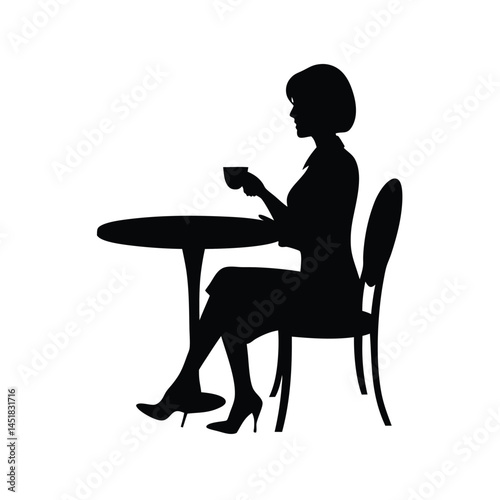 Silhouette of a woman sitting at a table enjoying a cup of coffee