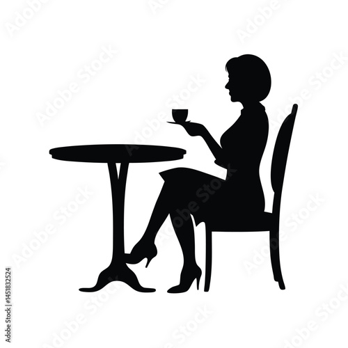 Silhouette of a woman sitting at a table enjoying a cup of coffee