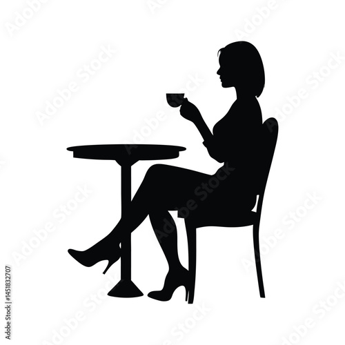 Silhouette of a woman sitting at a table enjoying a cup of coffee