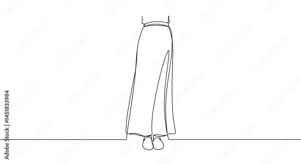 Elegant woman standing in a long skirt against a minimal backdrop