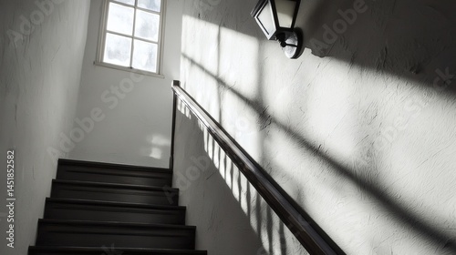 138. Stairs with handrail shadows from window and wall sconce