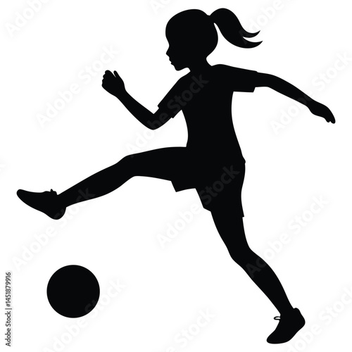 Silhouette of a young girl playing soccer, kicking the ball