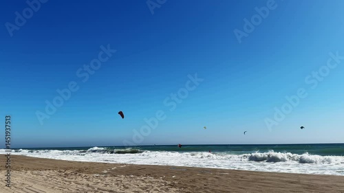 Kitesurfing surfing at the local beach of Spain. High quality 4k footage