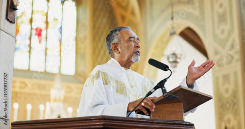 Worship, pastor and praying in church, faith and preaching with microphone for Christianity or gospel. Podium, preacher and mature man with speech for religion, Easter service or sermon to praise God