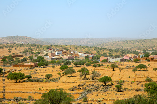 Typical village in semi-desert of Morocco on a sunny day photo