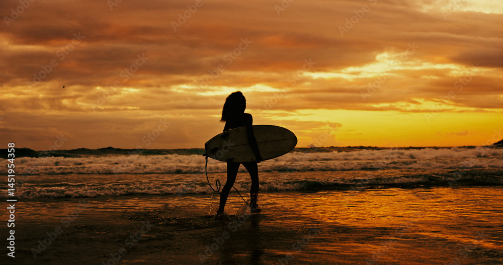 Obraz premium Silhouette, sunset and person with surfboard, water and adventure for surfer on holiday, space or beach. Summer vacation, travel and woman with fitness for sport, evening and hobby in nature or ocean