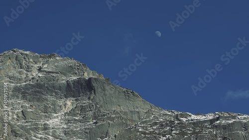 Huge Mountain Rock and Moon on blue sky