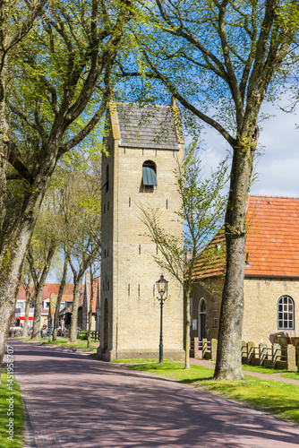 Street leading to the historic church tower of Ballum, Ameland, Netherlands
