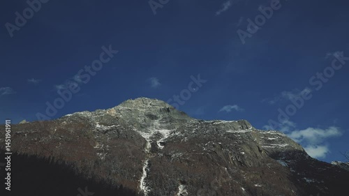 Half Moon on Blue Sky with Huge Mountain Rock  