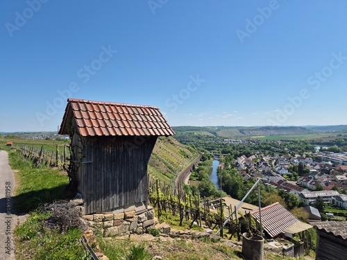 Wooden hut for winegrowers in the vineyard with blue sky and wide landscape with good view from the mountain