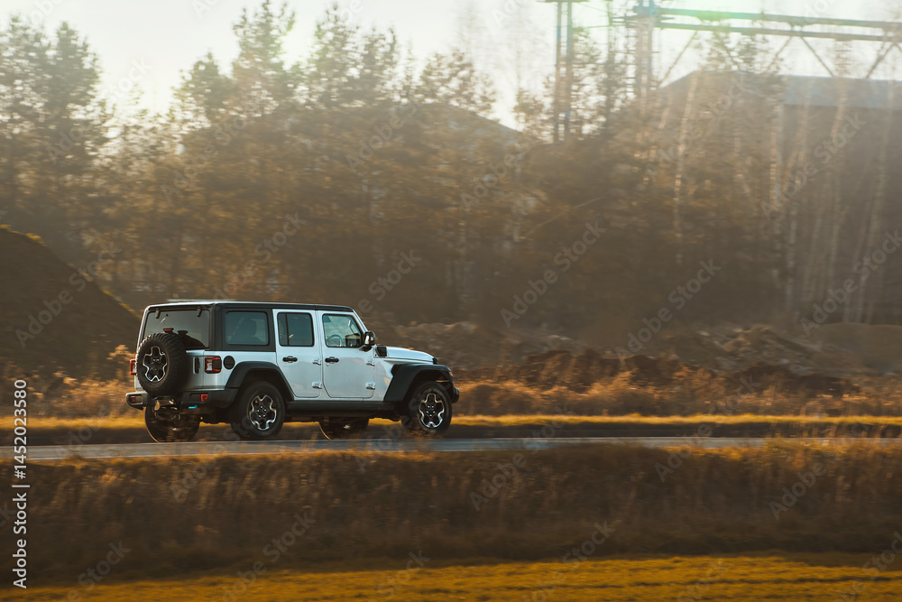 SUV driving through rural landscape