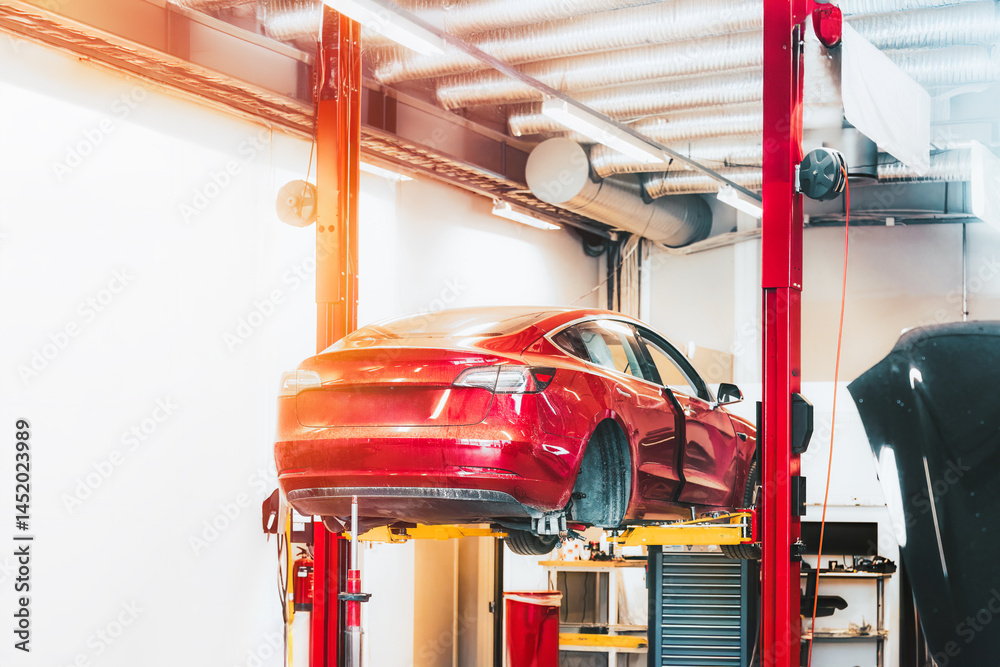 Modern EV being repaired in a garage by professionals