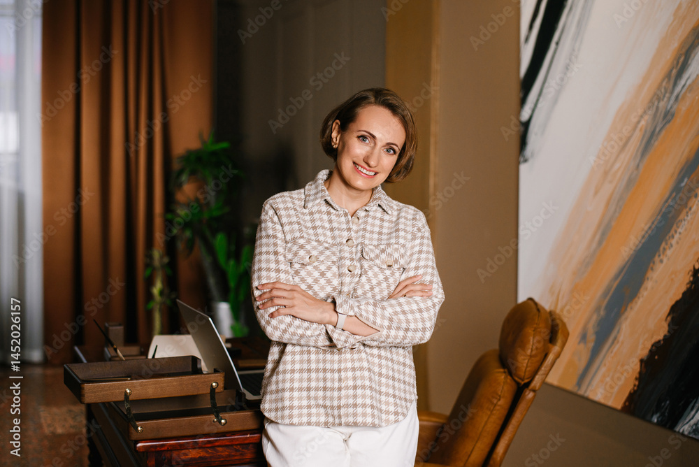 Smiling Woman With Arms Crossed In Office