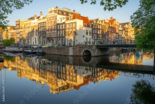 Photography Amsterdam canal houses and bridge reflect on calm canal water