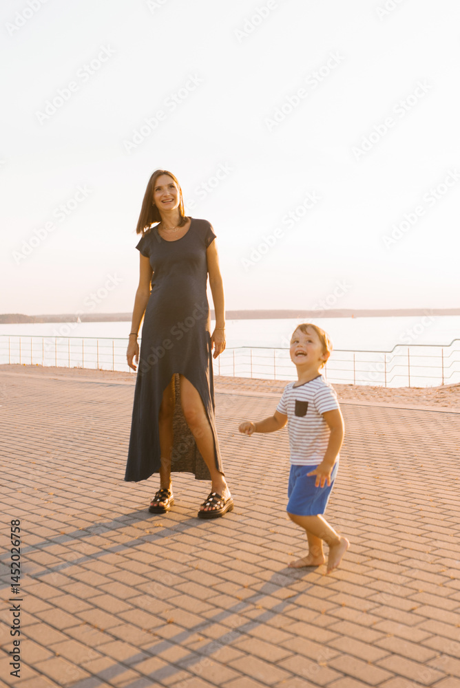 Pregnant Mother Enjoying Time With Her Laughing Son