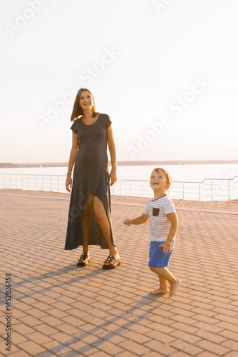 Obraz na płótnie Pregnant Mother Enjoying Time With Her Laughing Son w salonie
