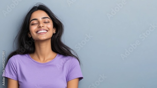 Woman with closed eyes, smiling, exuding serenity and happiness, peaceful.