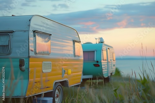 Vintage Caravan Sunset: Two Retro Trailers Parked by the Sea, Enjoying the Golden Hour with Breathtaking Ocean Views during a Serene Summer Vacation. Coastal Camping Adventure.