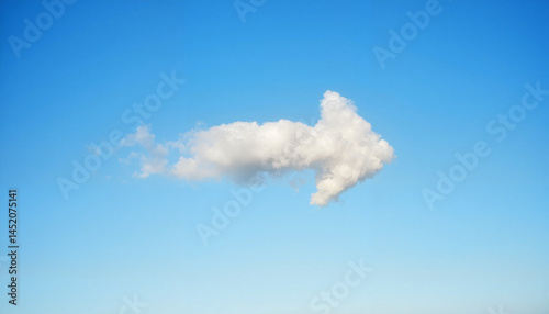 Arrow-shaped cloud drifting in clear blue sky, nature's symbolism
