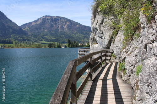 Panoramic path along the shore of Lake Wolfgang in Strobl. View of Lake Wolfgang and surrounding mountains. Austria, Europe.