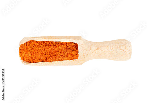 Dry spices of paprika in a wooden scoop isolated on a white background, top view