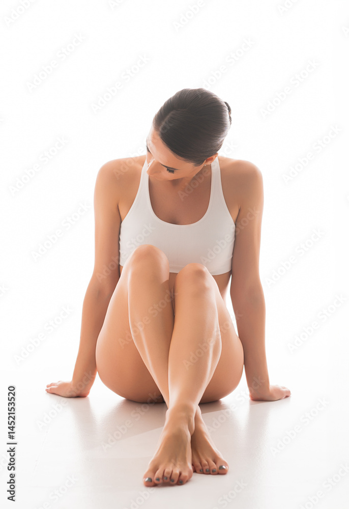 Naklejka premium Young, fit and beautiful brunette woman in white swimsuit isolated on white background. Healthcare, diet, sport and fitness concept.