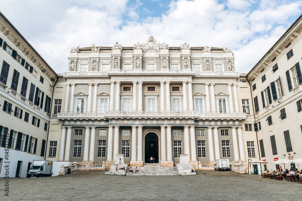 Genoa, Italy - September 22, 2024: Majestic neoclassical facade of Palazzo Ducale with columns and statues dominates the historic city center. Genoa, Italy - September 22, 2024: Majestic neoclassical facade of Palazzo Ducale with columns and statues dominates the historic city center.