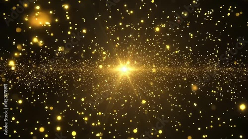 Golden particles float toward a central bright light source on a black background.
