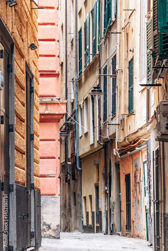 Fototapeta Naklejka Na Ścianę i Meble -  Genoa, Italy - September 22, 2024: Narrow alleys in the historic center of Genoa, showcasing the charm of the old town with its winding streets and traditional architecture