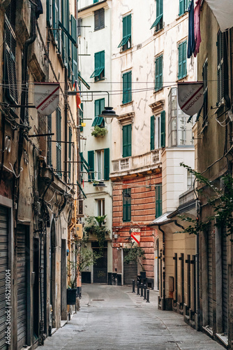 Fototapeta Naklejka Na Ścianę i Meble -  Genoa, Italy - September 22, 2024: Narrow alleys in the historic center of Genoa, showcasing the charm of the old town with its winding streets and traditional architecture