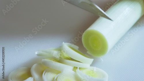 Food preparation. Close-up of slicing leeks. Slow motion footage 100fps.