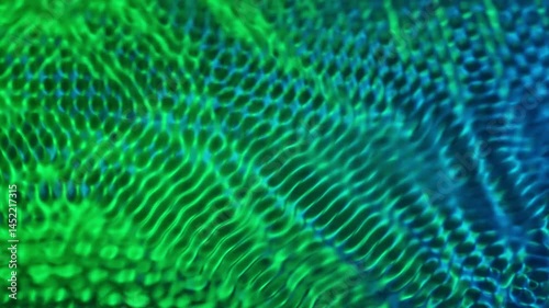 Green swirling, undulating water surface in motion, created by sound vibrations. Selected focus. Slow motion video.