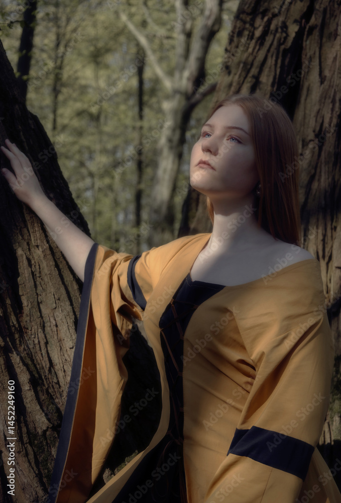 young woman in medieval dress in spring forest