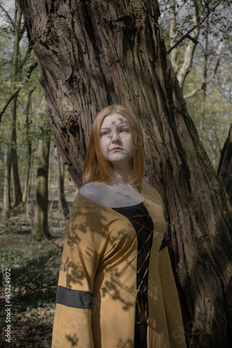 Obraz na płótnie young woman in medieval dress in spring forest w salonie