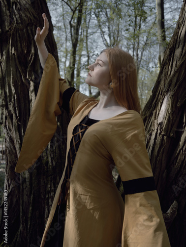 young woman in medieval dress in spring forest