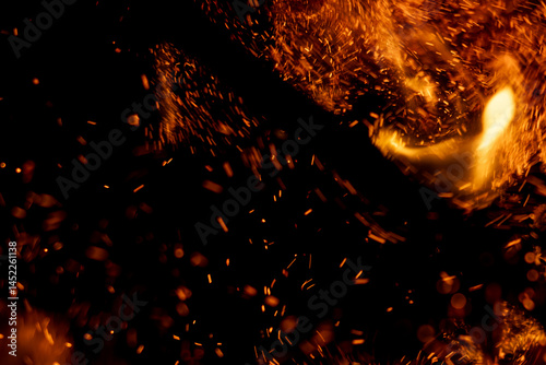 A black background with a lot of fire and smoke