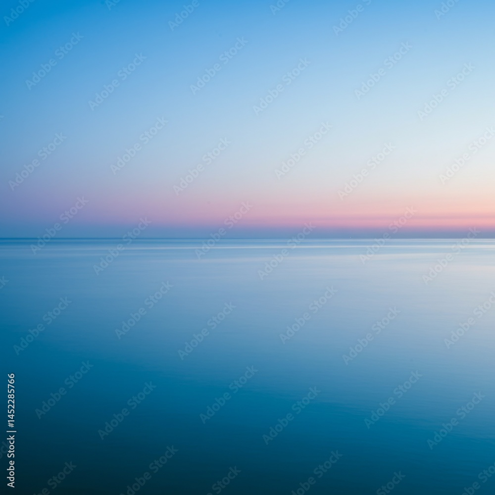 Obraz premium Serene Ocean Sunset: Pink And Blue Hues Over Calm Water
