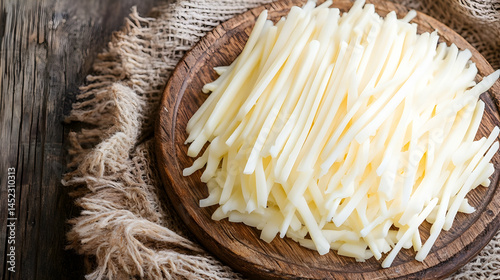 Prepared potato sticks on wooden cutting board for cooking or preparing snacks