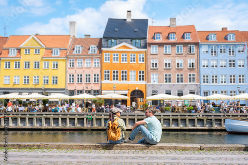 Photography Colorful waterfront buildings and relaxed visitors in charming Copenhagen Denmar