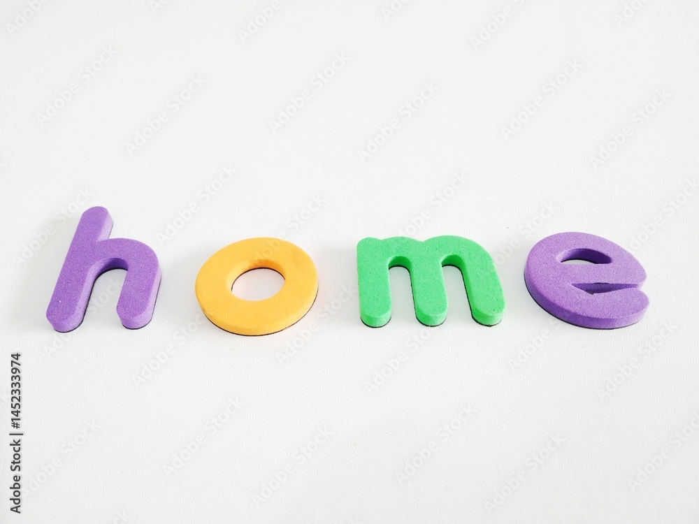 Naklejka premium Letter magnets home close up on white background