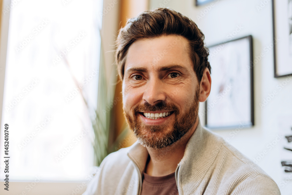 Portrait of smiling creative man standing in his modern apartment Portrait of smiling creative man standing in his modern apartment