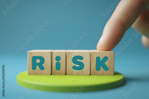 Wooden Blocks Spelling Risk with a Finger About to Touch